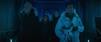 Movie still from “Godzilla: King of the Monsters” (2019), directed by Michael Dougherty – A group of people standing in a room at night; Medium shot, Low angle