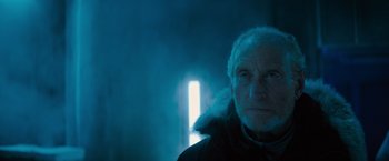 Movie still from “Godzilla: King of the Monsters” (2019), directed by Michael Dougherty – An old man with a beard is standing in the dark; Close Up shot, Low angle