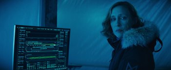Movie still from “Godzilla: King of the Monsters” (2019), directed by Michael Dougherty – A woman standing in front of a computer monitor; Close Up shot, Over the shoulder angle