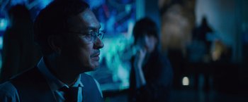 Movie still from “Godzilla: King of the Monsters” (2019), directed by Michael Dougherty – A man and a woman in a dark room; Close Up shot, Over the shoulder angle