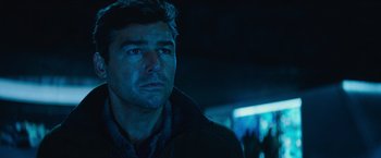 Movie still from “Godzilla: King of the Monsters” (2019), directed by Michael Dougherty – A person wearing a jacket; Close Up shot, Over the shoulder angle