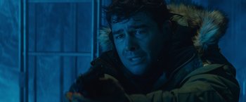 Movie still from “Godzilla: King of the Monsters” (2019), directed by Michael Dougherty – A person wearing a jacket; Close Up shot, Over the shoulder angle