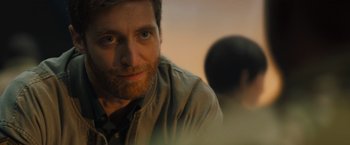 Movie still from “Godzilla: King of the Monsters” (2019), directed by Michael Dougherty – A person wearing a jacket; Close Up shot, Over the shoulder angle