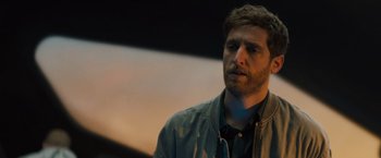 Movie still from “Godzilla: King of the Monsters” (2019), directed by Michael Dougherty – A person wearing a jacket; Close Up shot, Over the shoulder angle