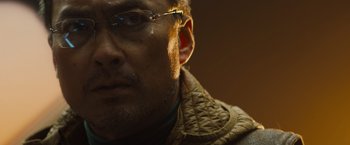 Movie still from “Godzilla: King of the Monsters” (2019), directed by Michael Dougherty – A person wearing glasses; Close Up shot, Low angle