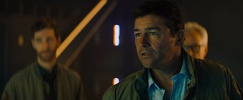 Movie still from “Godzilla: King of the Monsters” (2019), directed by Michael Dougherty – A person wearing a green jacket; Close Up shot, Over the shoulder angle