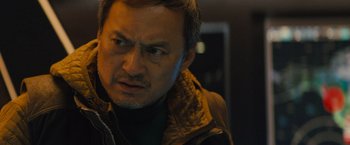 Movie still from “Godzilla: King of the Monsters” (2019), directed by Michael Dougherty – A person wearing a jacket; Close Up shot, Low angle