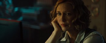 Movie still from “Godzilla: King of the Monsters” (2019), directed by Michael Dougherty – A person sitting with her hand on her chin; Close Up shot, Over the shoulder angle