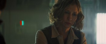 Movie still from “Godzilla: King of the Monsters” (2019), directed by Michael Dougherty – A person wearing a dress shirt; Close Up shot, Over the shoulder angle