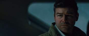 Movie still from “Godzilla: King of the Monsters” (2019), directed by Michael Dougherty – A person wearing a jacket; Close Up shot, Low angle