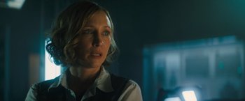 Movie still from “Godzilla: King of the Monsters” (2019), directed by Michael Dougherty – A person wearing a shirt and vest; Close Up shot, Over the shoulder angle