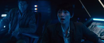 Movie still from “Godzilla: King of the Monsters” (2019), directed by Michael Dougherty – A person sitting in a car at night; Close Up shot, Over the shoulder angle