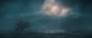 Movie still from “Godzilla: King of the Monsters” (2019), directed by Michael Dougherty – An oil rig in the middle of the ocean under a cloudy sky; Extreme Wide shot, Low angle