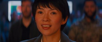 Movie still from “Godzilla: King of the Monsters” (2019), directed by Michael Dougherty – A person with short black hair; Close Up shot, Over the shoulder angle