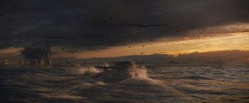Movie still from “Godzilla: King of the Monsters” (2019), directed by Michael Dougherty – An image of an airplane flying in the sky over the ocean; Extreme Wide shot, High angle