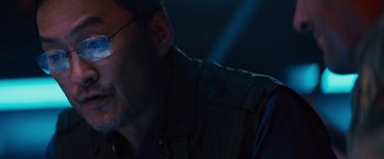 Movie still from “Godzilla: King of the Monsters” (2019), directed by Michael Dougherty – A person wearing glasses and a jacket; Close Up shot, Low angle
