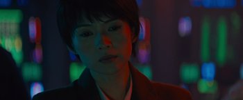 Movie still from “Godzilla: King of the Monsters” (2019), directed by Michael Dougherty – A woman with short black hair wearing a jacket; Close Up shot, Low angle