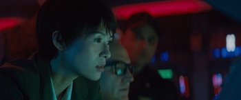 Movie still from “Godzilla: King of the Monsters” (2019), directed by Michael Dougherty – A group of people sitting next to each other in a room; Close Up shot, Low angle