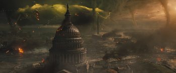 Movie still from “Godzilla: King of the Monsters” (2019), directed by Michael Dougherty – An image of an image of the capitol building in the middle of a city; Extreme Wide shot, Overhead angle