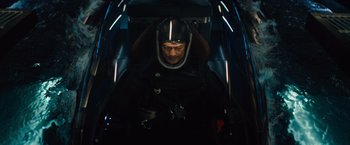 Movie still from “Godzilla: King of the Monsters” (2019), directed by Michael Dougherty – A man wearing a helmet inside of an airplane; Medium shot, Overhead angle