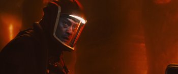 Movie still from “Godzilla: King of the Monsters” (2019), directed by Michael Dougherty – A man wearing a helmet with a light on it's face; Close Up shot, Low angle