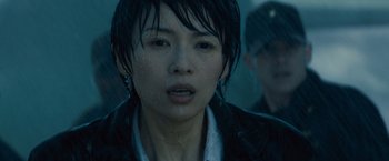 Movie still from “Godzilla: King of the Monsters” (2019), directed by Michael Dougherty – A person wearing a jacket; Close Up shot, Over the shoulder angle