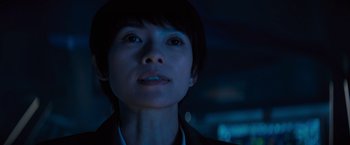 Movie still from “Godzilla: King of the Monsters” (2019), directed by Michael Dougherty – A woman with short black hair looking up at the sky; Close Up shot, Low angle