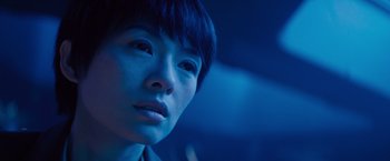Movie still from “Godzilla: King of the Monsters” (2019), directed by Michael Dougherty – A person's face in the dark; Close Up shot, Low angle