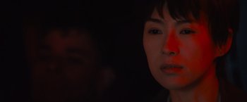 Movie still from “Godzilla: King of the Monsters” (2019), directed by Michael Dougherty – A woman with a red spot on her face; Close Up shot, Over the shoulder angle