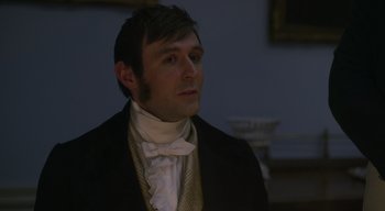 Movie still from “Ammonite” (2020), directed by Francis Lee – A man wearing a suit and a white shirt; Close Up shot, Over the shoulder angle