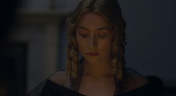 Movie still from “Ammonite” (2020), directed by Francis Lee – A young woman in a black dress with her eyes closed; Close Up shot, Over the shoulder angle