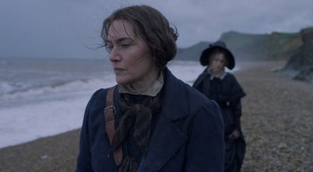 Movie still from “Ammonite” (2020), directed by Francis Lee – A woman in a blue coat and a woman in a black coat; Medium shot, Over the shoulder angle