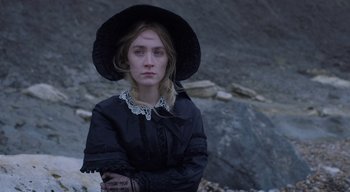 Movie still from “Ammonite” (2020), directed by Francis Lee – A woman in a black dress and a black hat; Close Up shot, High angle