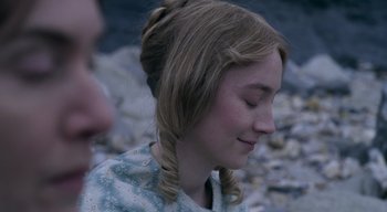 Movie still from “Ammonite” (2020), directed by Francis Lee – A young girl with her eyes closed with her hair in a braid; Close Up shot, Over the shoulder angle