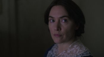 Movie still from “Ammonite” (2020), directed by Francis Lee – A person wearing a white shirt; Close Up shot, Over the shoulder angle