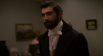 Movie still from “Ammonite” (2020), directed by Francis Lee – A man in a suit and a white bow tie; Close Up shot, Over the shoulder angle