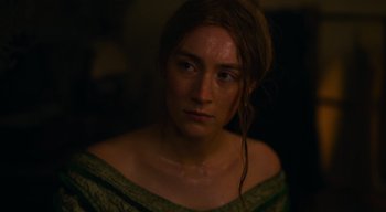 Movie still from “Ammonite” (2020), directed by Francis Lee – A person wearing a green dress; Close Up shot, High angle