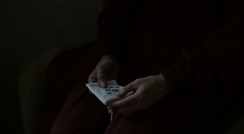 Movie still from “Ammonite” (2020), directed by Francis Lee – A person holding a nintendo wii game controller in their hands; Extreme Close Up shot, Overhead angle