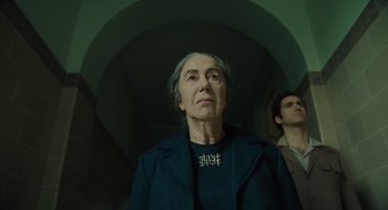 Movie still from “Golda” (2023), directed by Guy Nattiv – An older woman wearing a black jacket looking up; Close Up shot, Low angle