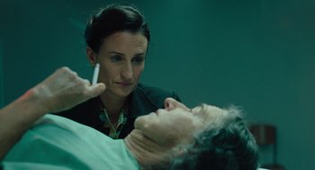 Movie still from “Golda” (2023), directed by Guy Nattiv – A woman looking at a man's face in a green room; Close Up shot, Over the shoulder angle