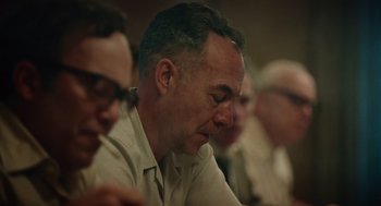 Movie still from “Golda” (2023), directed by Guy Nattiv – A group of men sitting around a table; Close Up shot, Over the shoulder angle