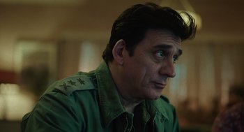 Movie still from “Golda” (2023), directed by Guy Nattiv – A person wearing a green jacket; Close Up shot, Low angle