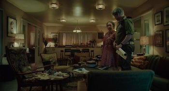 Movie still from “Golda” (2023), directed by Guy Nattiv – A man and a woman standing in a living room; Wide shot, Over the shoulder angle