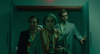 Movie still from “Golda” (2023), directed by Guy Nattiv – A group of people standing in front of a wall; Medium shot, Low angle