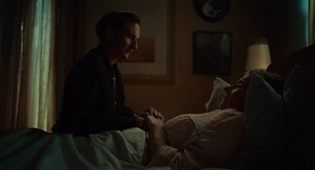 Movie still from “Golda” (2023), directed by Guy Nattiv – A woman in a bed with a person in a hospital bed; Medium shot, Over the shoulder angle