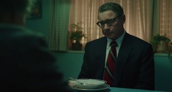 Movie still from “Golda” (2023), directed by Guy Nattiv – A man sitting at a table with a bowl of soup; Medium shot, Over the shoulder angle