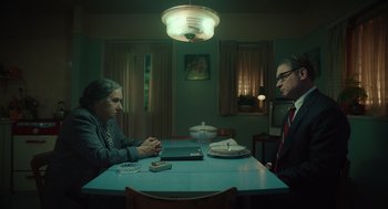 Movie still from “Golda” (2023), directed by Guy Nattiv – A man and a woman sitting at a dinner table; Medium shot, High angle