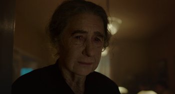 Movie still from “Golda” (2023), directed by Guy Nattiv – An older woman with a sad look on her face; Close Up shot, Over the shoulder angle
