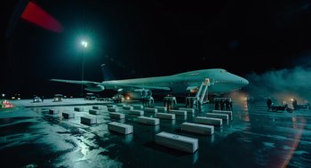 Movie still from “Golda” (2023), directed by Guy Nattiv – An airplane sitting on top of an airport runway; Extreme Wide shot, High angle