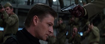 Movie still from “GoldenEye” (1995), directed by Martin Campbell – A person holding a gun; Close Up shot, Low angle